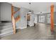 Open concept living space with staircase, LVP flooring, and a view of the bathroom at 922 Houston Heights Rd, Charlotte, NC 28262