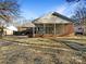 Brick house with a large covered patio and grassy backyard at 1005 Woodland Dr, Gastonia, NC 28054