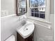 Updated bathroom with pedestal sink and window at 1005 Woodland Dr, Gastonia, NC 28054