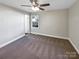 Spacious bedroom with ceiling fan and carpeted floors at 1005 Woodland Dr, Gastonia, NC 28054