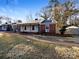 Brick ranch home with a covered porch and landscaped yard at 1005 Woodland Dr, Gastonia, NC 28054