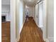 Long hallway with light wood flooring, leading to other rooms at 1005 Woodland Dr, Gastonia, NC 28054