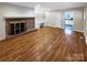 Living room featuring hardwood floors and a brick fireplace at 1005 Woodland Dr, Gastonia, NC 28054