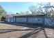 Triple-car detached garage with light green doors and a gravel driveway at 1024 Queens Rd, Charlotte, NC 28207