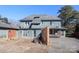 Back of the house with large yard, brick and stucco exterior, and multiple doors at 1024 Queens Rd, Charlotte, NC 28207