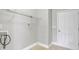 A clean and simple laundry room with tile floors, white walls, and practical shelving at 10319 Barrands Ln, Charlotte, NC 28278