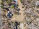 An aerial view of the property shows the home, outlining the lot and mature trees on the grounds at 107 Cambridge Rd, Huntersville, NC 28078