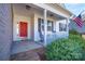 Inviting front porch with rocking chair and American flag at 1361 Colwick Ln, Rock Hill, SC 29732