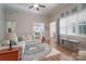 Comfortable living room with large windows and a circular rug at 1361 Colwick Ln, Rock Hill, SC 29732