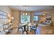 Bright dining area features a round table, stylish chairs, modern chandelier and seamless flow into an open living space at 1381 6Th Ne St, Hickory, NC 28601