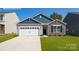 Charming single-story home featuring a stone facade, a two-car garage, and a well-manicured lawn at 1381 6Th Ne St, Hickory, NC 28601