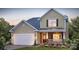 Charming two-story home featuring stone accents, a welcoming porch, and attached two-car garage at 1386 6Th Ne St, Hickory, NC 28601