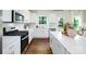 Bright kitchen featuring stainless steel appliances, white cabinetry, and a large island with quartz countertops at 1386 6Th Ne St, Hickory, NC 28601