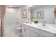Well-lit bathroom with double vanity, white cabinets, and bathtub with shower at 1427 5Th Street Ne Dr, Hickory, NC 28601