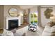 Cozy living room features a fireplace, round mirror, and sliding glass doors to the outdoors at 1427 5Th Street Ne Dr, Hickory, NC 28601