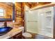 Modern bathroom with a glass-enclosed shower and rustic wood details at 1505 S Ridge Ave, Kannapolis, NC 28083