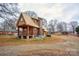 Rustic cabin-style home with a stone base and a partially cleared yard at 1505 S Ridge Ave, Kannapolis, NC 28083