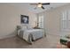 Well-lit bedroom with soft carpet, a ceiling fan, and a decorative lamp at 18211 Ebenezer Dr, Cornelius, NC 28031