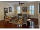 Cozy living room with hardwood floors, neutral decor, and ample natural light from large windows at 18211 Ebenezer Dr, Cornelius, NC 28031