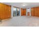 Finished basement features wood paneling, carpeting, and a sliding glass door at 1908 Starbrook Dr, Charlotte, NC 28210