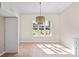 Bright dining room features modern chandelier, a large window, and neutral paint at 212 Catalina Dr, Mooresville, NC 28117