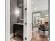 Modern powder room with dark vanity and view to the living room at 2715 Phillips Gate Dr, Charlotte, NC 28210