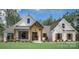 White farmhouse exterior with a welcoming front porch and landscaping at 304 Tradition Dr, Mount Gilead, NC 27306