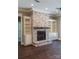 Whitewashed brick fireplace with built-in shelving at 304 Tradition Dr, Mount Gilead, NC 27306