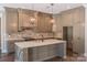 Spacious kitchen with gray cabinets, granite counters, and brick backsplash at 304 Tradition Dr, Mount Gilead, NC 27306