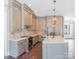 Modern kitchen with white cabinets, quartz countertops, and stainless steel appliances at 304 Tradition Dr, Mount Gilead, NC 27306