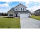 Two-story house with gray siding, stone accents, and a white garage door at 3070 Swallowtail Ln, Kannapolis, NC 28027