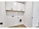 Laundry room with white cabinets and flooring at 3070 Swallowtail Ln, Kannapolis, NC 28027