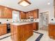 Kitchen boasts an island, ample cabinetry, and tile floors at 315 Harvard Dr, Albemarle, NC 28001