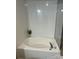 Clean bathroom with an oval-shaped bathtub and white tile at 32139 Blakley Dr, Albemarle, NC 28001