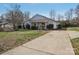 A single-story house with a concrete driveway and well-kept front yard landscaping at 3317 Green Meadow Dr, Charlotte, NC 28269