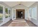 Open sunroom with glass paneled doors looking into another room, and neutral carpet at 3317 Green Meadow Dr, Charlotte, NC 28269