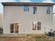 Rear view of house showcasing siding, windows, and patio at 4910 Muskogee Dr, Charlotte, NC 28212