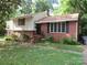 Brick ranch house with steps leading to the entrance and a spacious yard at 5045 Murrayhill Rd, Charlotte, NC 28210