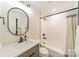 Clean bathroom with a bathtub, updated vanity, and black fixtures at 531 Manhasset Rd, Charlotte, NC 28209