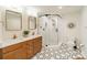 Modern bathroom with double vanity, hexagon tile floor, and glass shower at 531 Manhasset Rd, Charlotte, NC 28209