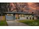 Charming, renovated ranch home with a modern door, gray and white brick exterior and manicured front yard at 531 Manhasset Rd, Charlotte, NC 28209