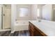 Bathroom with soaking tub, shower, and vanity with solid surface counter at 5326 Kiev Dr, Charlotte, NC 28216