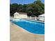 A fenced swimming pool with crystal blue water and an adjacent building for storage or a changing room at 6328 W Nc 10 Hwy, Hickory, NC 28602