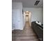 Hallway with wood-look floors leads to an open living area, complemented by neutral walls and a comfortable sofa at 7132 Somerford Rd, Charlotte, NC 28215