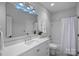 Modern bathroom with a bathtub, shower, and white vanity at 8827 Blooming Arbor St, Huntersville, NC 28078