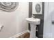 Stylish pedestal sink in a small powder room at 9353 Creedmore Hills Dr, Charlotte, NC 28214