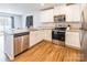 Modern kitchen with white cabinets, stainless steel appliances, and granite countertops at 9353 Creedmore Hills Dr, Charlotte, NC 28214