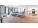 Open living room with gray sectional sofa and kitchen view at 9353 Creedmore Hills Dr, Charlotte, NC 28214
