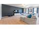 Spacious living room with gray sectional sofa and large TV at 9353 Creedmore Hills Dr, Charlotte, NC 28214