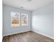 Simple bedroom with wood floors and two large windows at 109 E Broad St, Salisbury, NC 28144